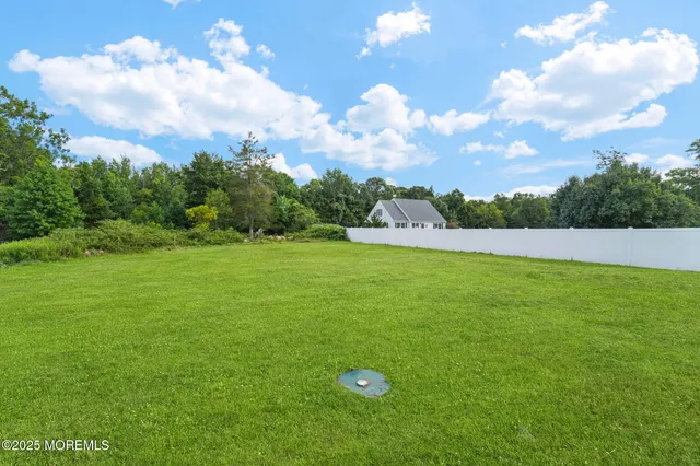 an aerial view of a house with a yard and swimming pool