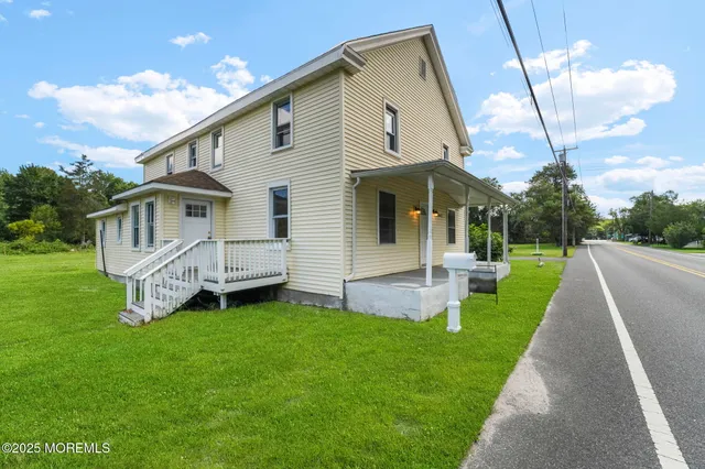 a view of a house with a yard and a garden