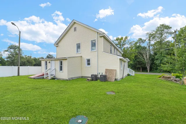 a view of a house with a yard and deck