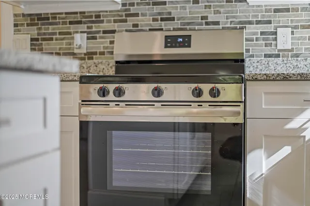a stove top oven sitting inside of a kitchen