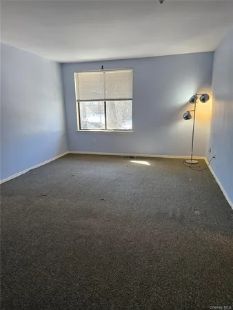 an empty room with a empty space and window