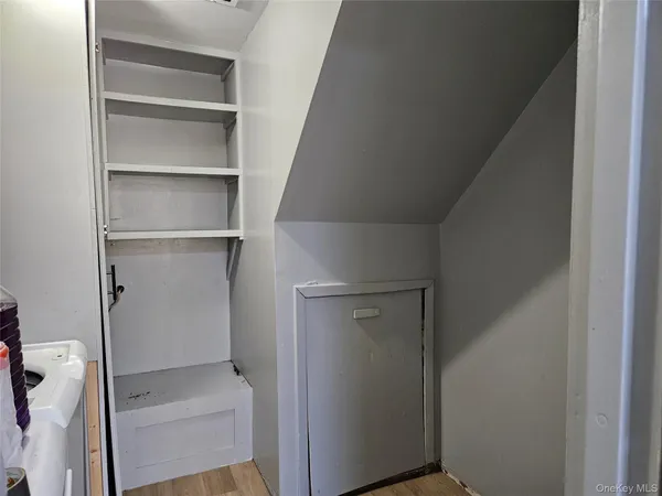 a view of walk in closet with empty racks