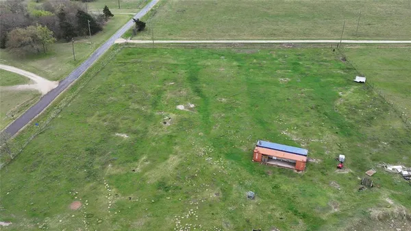 a view of a yard with a wooden fence