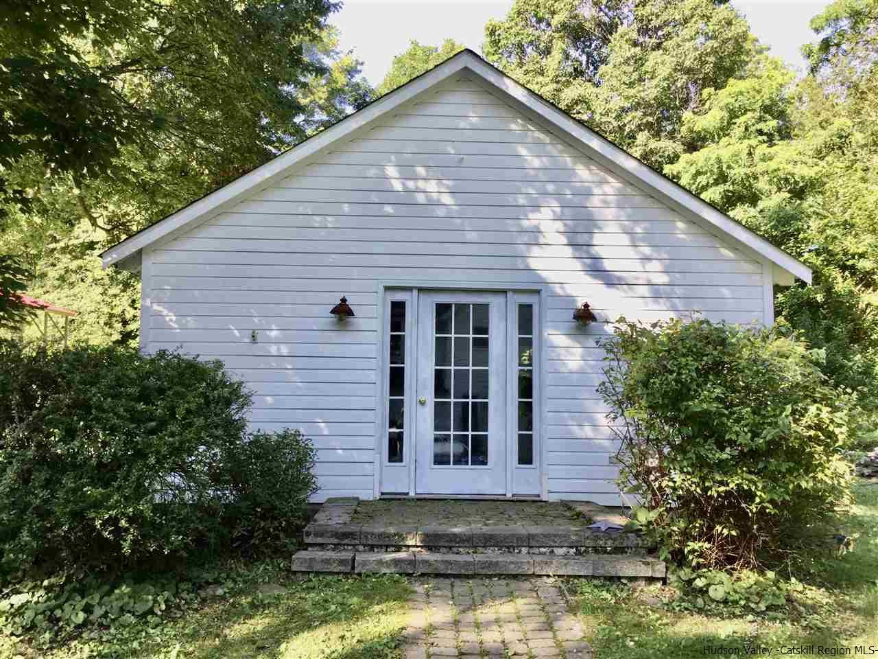 23 Bruyn Turnpike Wallkill, NY 12589 - Photo 5 of 19 a view of a house with large windows and a small yard