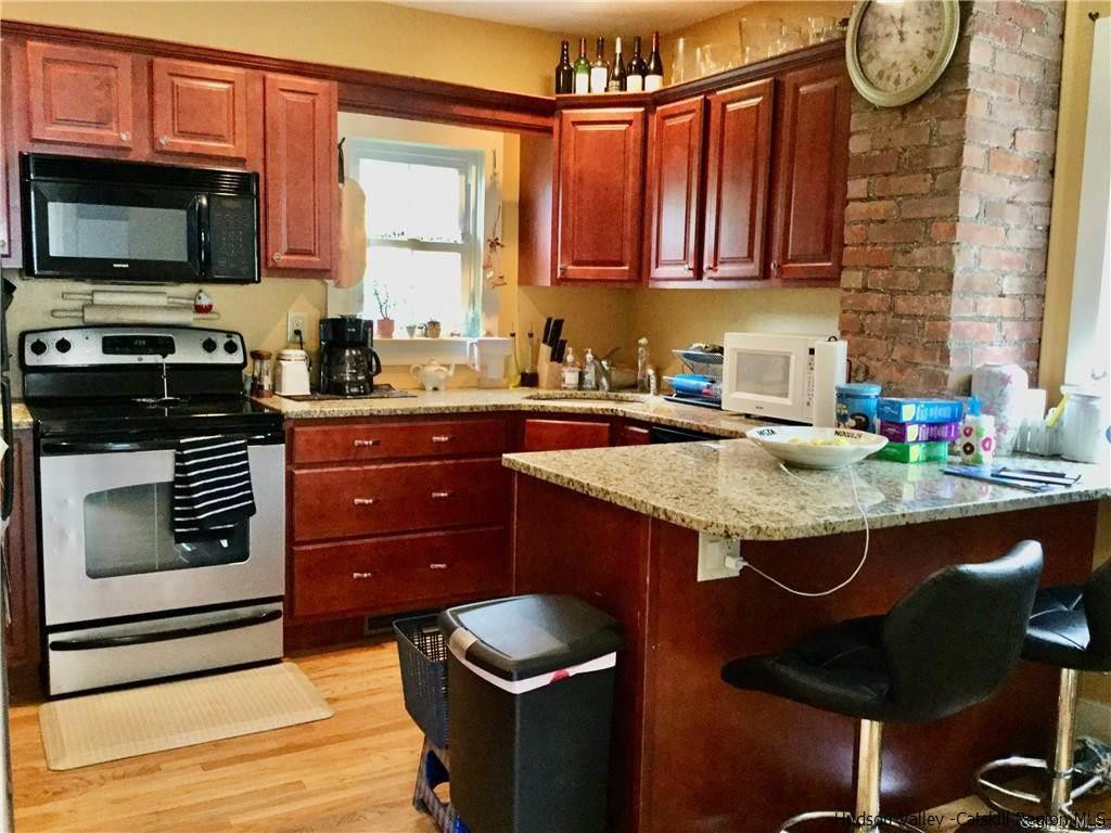 23 Bruyn Turnpike Wallkill, NY 12589 - Photo 7 of 19 a kitchen with stainless steel appliances granite countertop a stove a sink and a microwave