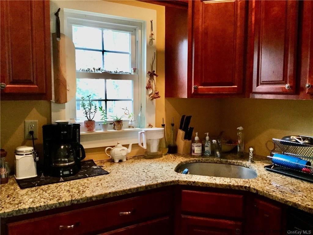 23 Bruyn Turnpike Wallkill, NY 12589 - Photo 8 of 19 a kitchen with granite countertop a sink a stove and cabinets
