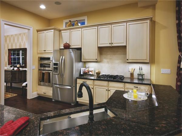 a kitchen with stainless steel appliances granite countertop a stove refrigerator sink and cabinets