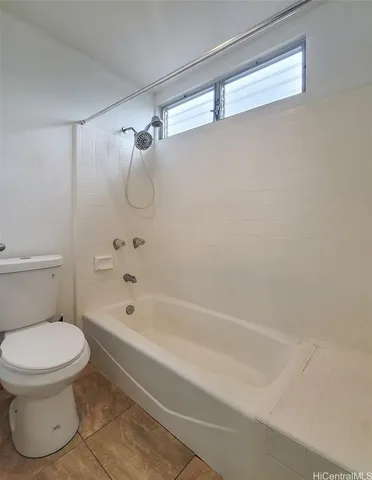 a bathroom with a toilet and a bathtub
