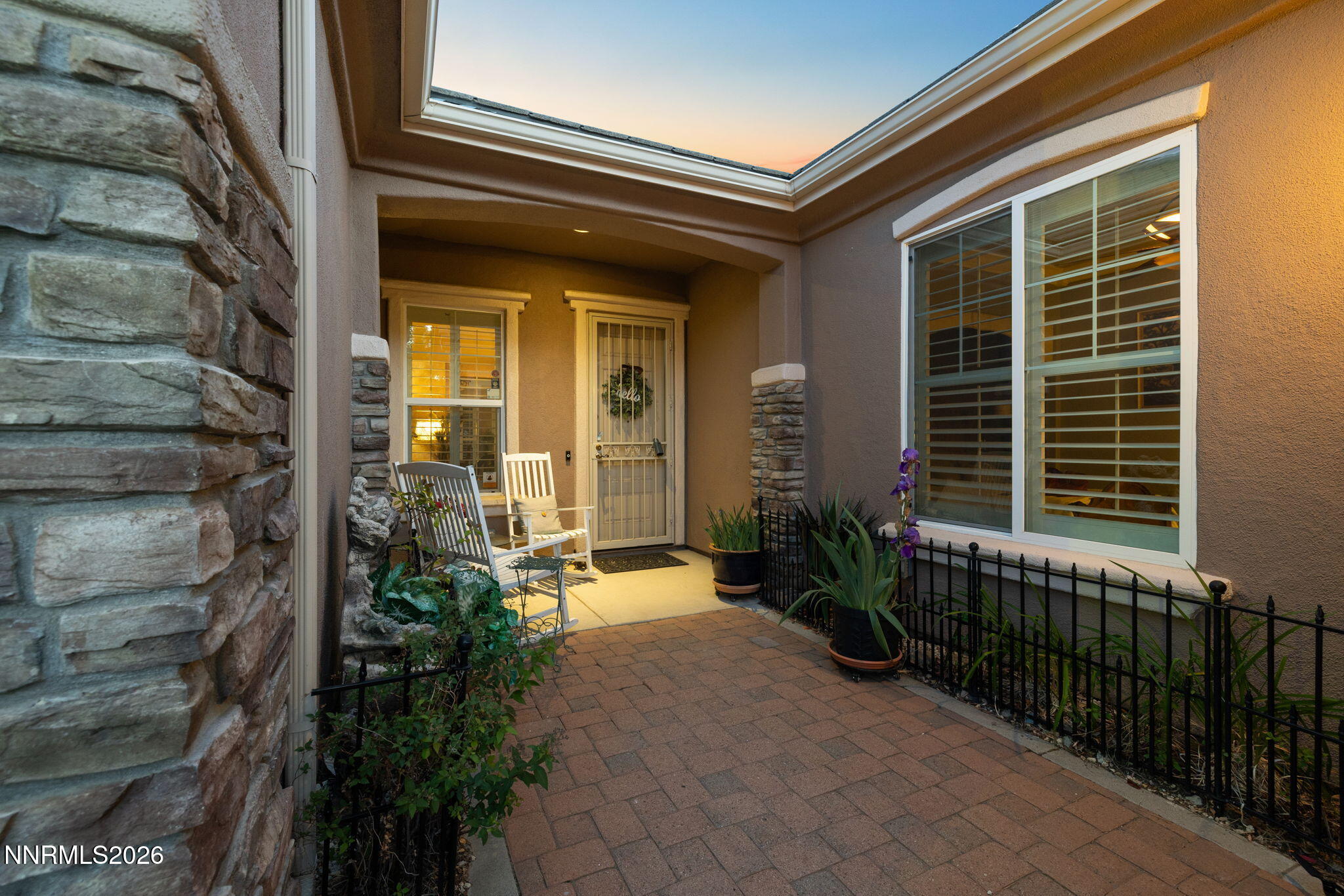 9160 Quilberry Way Reno, NV 89523 - Photo 15 of 53 a porch with a table and potted plants