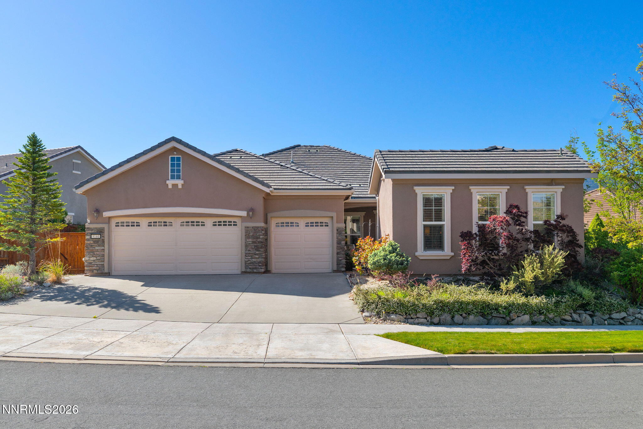9160 Quilberry Way Reno, NV 89523 - Photo 18 of 53 a front view of a house with a yard and garage