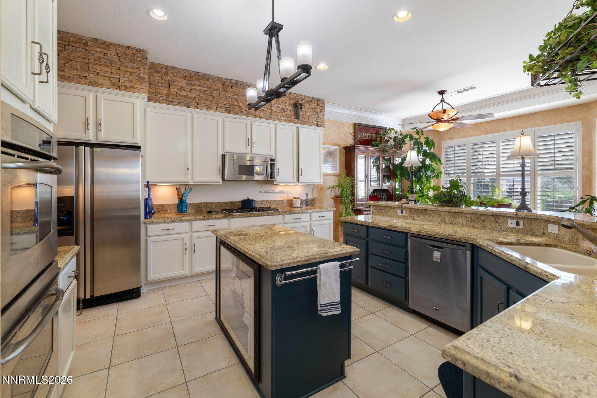 9160 Quilberry Way Reno, NV 89523 - Photo 25 of 53 a kitchen with stainless steel appliances granite countertop a sink a stove and a refrigerator