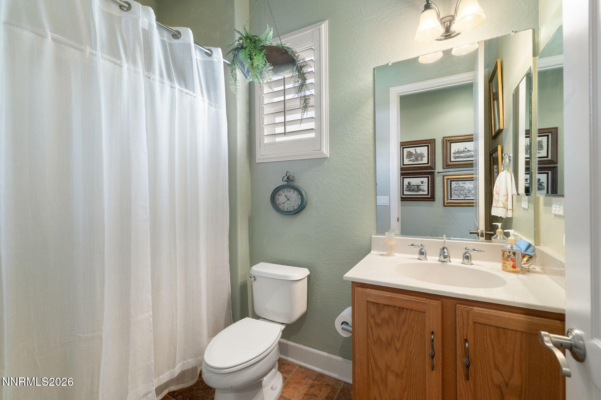 9160 Quilberry Way Reno, NV 89523 - Photo 35 of 53 a bathroom with a sink a toilet a mirror and shower curtain