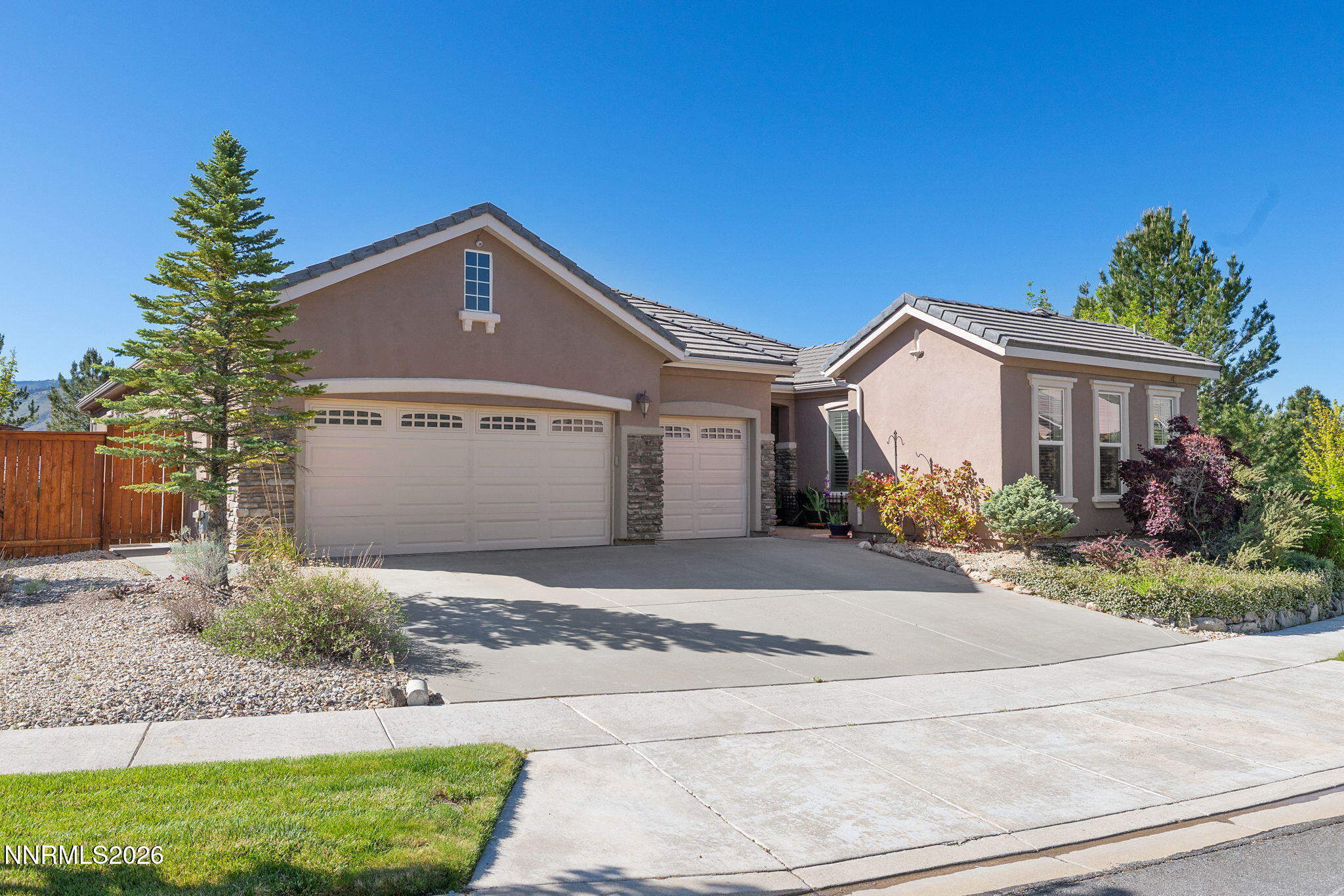 9160 Quilberry Way Reno, NV 89523 - Photo 53 of 53 a front view of a house with a yard and garage