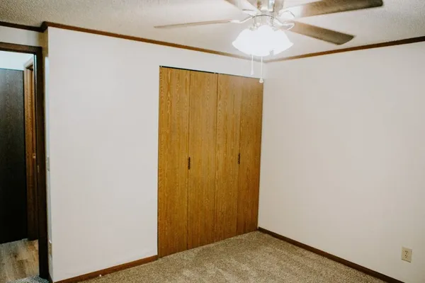 a view of a hallway with a chandelier fan
