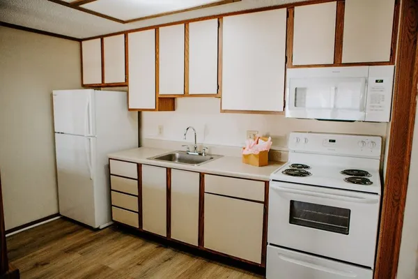 a kitchen with stainless steel appliances a refrigerator sink and cabinets