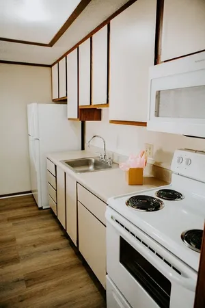a kitchen with a stove and a white refrigerator