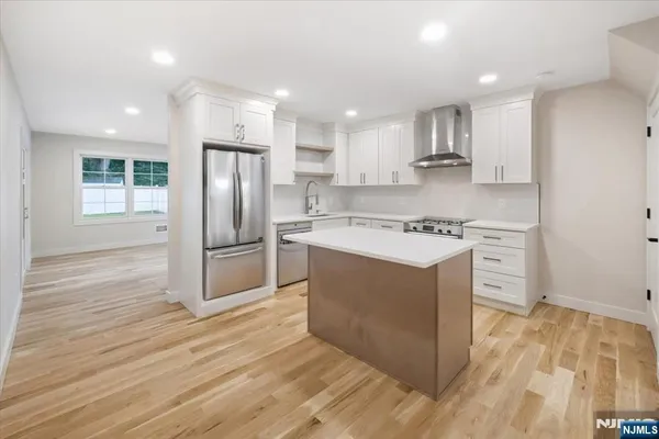 a kitchen with a white stove top oven and refrigerator