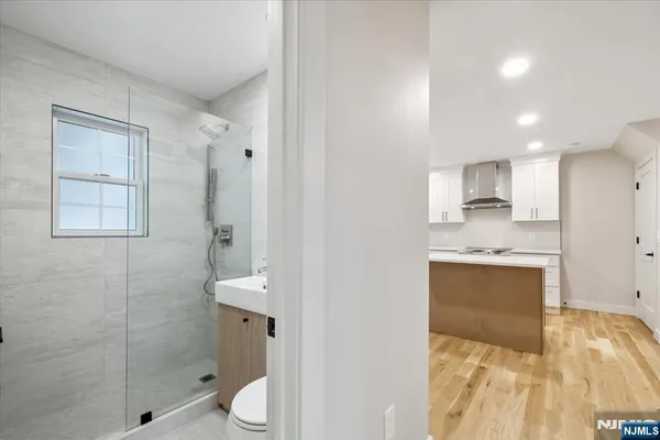 a bathroom with a sink a toilet and shower