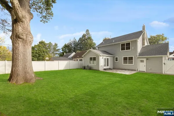 a view of a house with a backyard