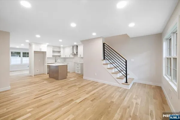 a view of a kitchen with a sink cabinets and wooden floor