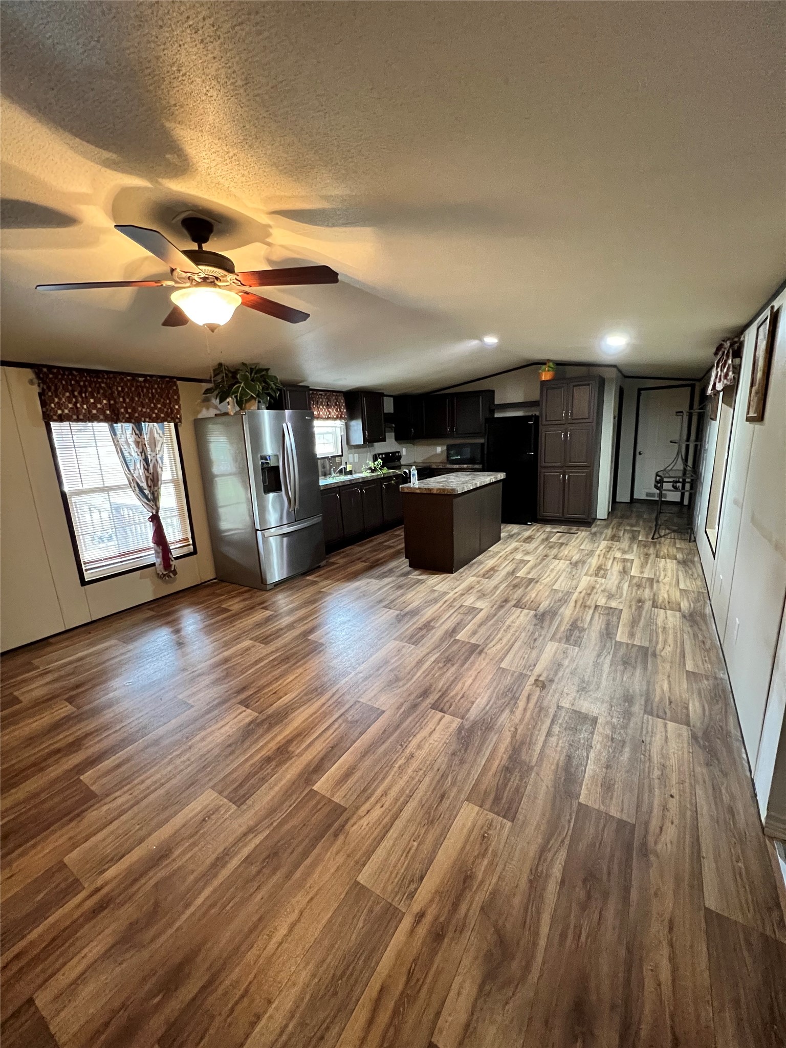 485 County Road 377 Cleveland, TX 77327 - Photo 11 of 16 a view of an empty room with wooden floor and windows