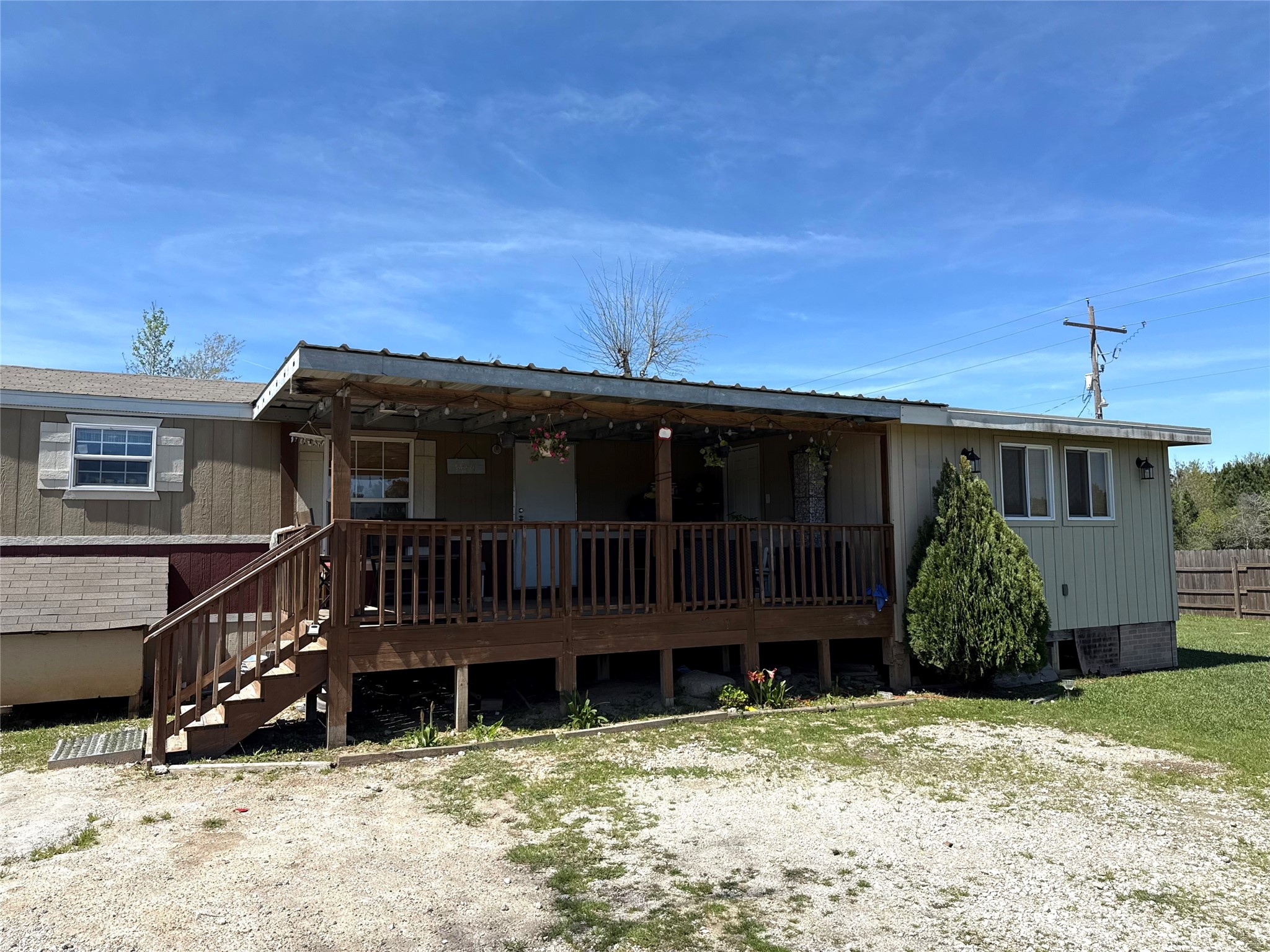 485 County Road 377 Cleveland, TX 77327 - Photo 6 of 16 a view of a house with a yard and wooden fence