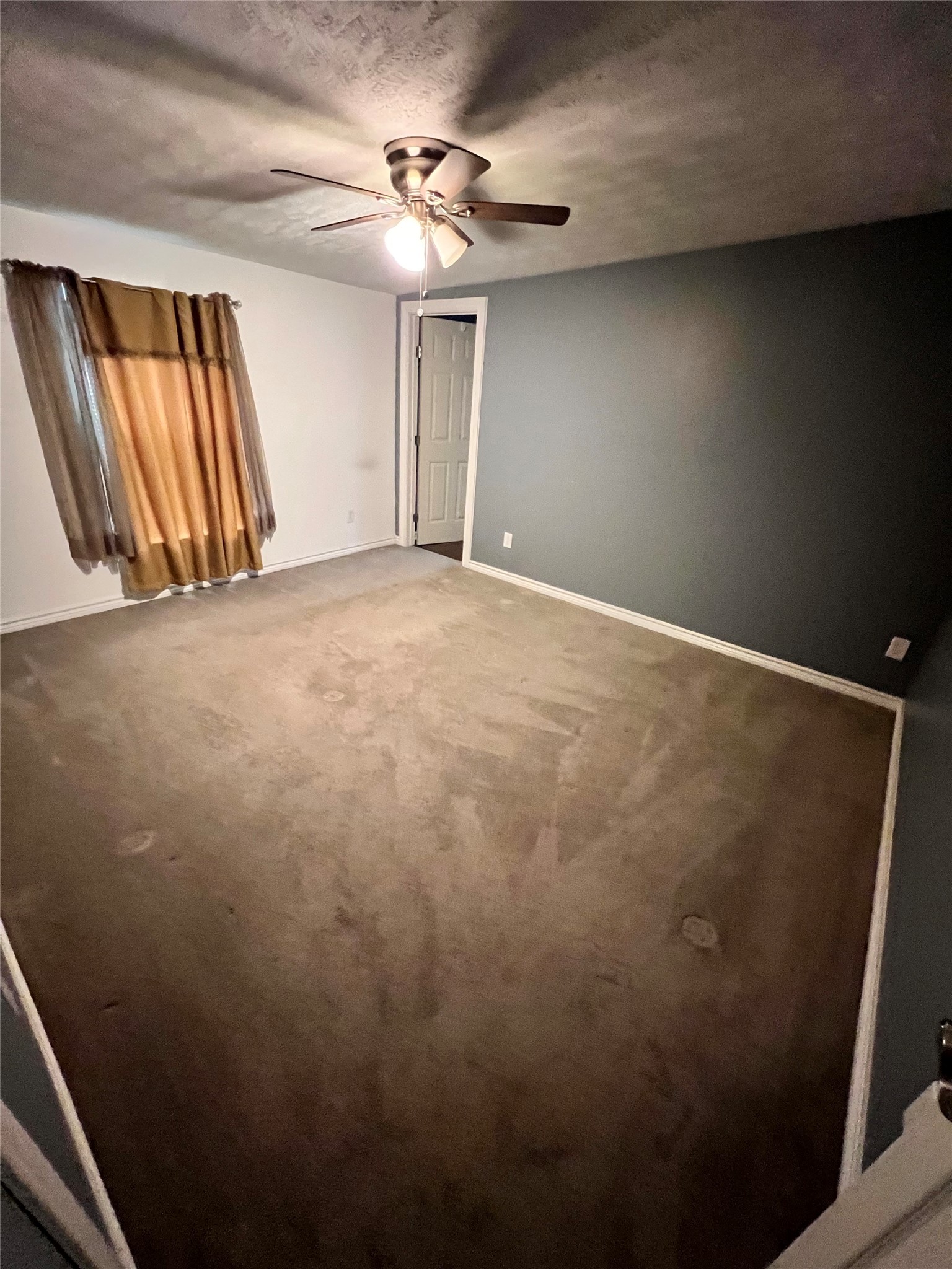 485 County Road 377 Cleveland, TX 77327 - Photo 8 of 16 an empty room with windows and fan