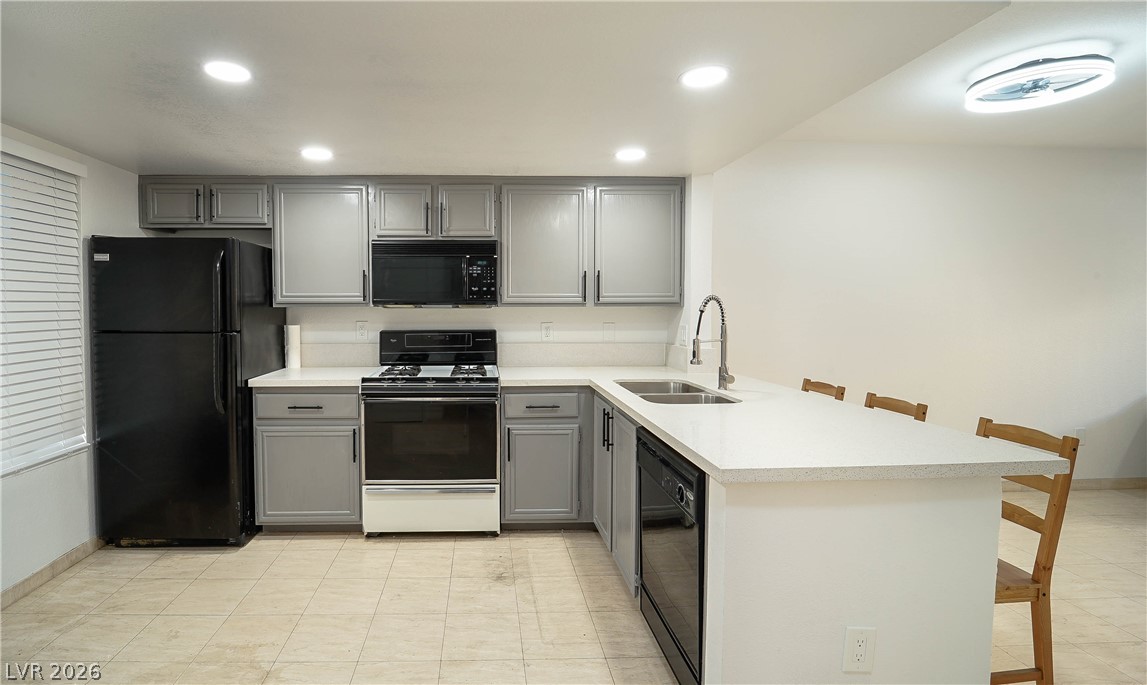 8070 West Russell Road, Unit 1099 Las Vegas, NV 89113 - Photo 9 of 31 A well-appointed kitchen features a practical island with seating, creating a functional and inviting culinary space.
