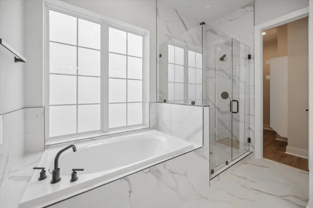 a bathroom with a tub and a shower