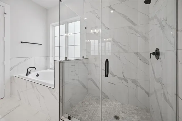 a bathroom with a bathtub and a shower