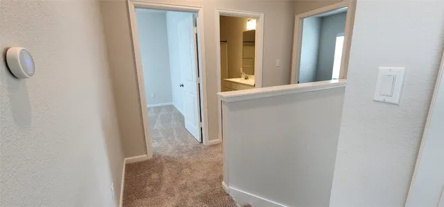 a view of a bathroom from a corridor