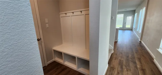 a view of hallway with stairs and wooden floor