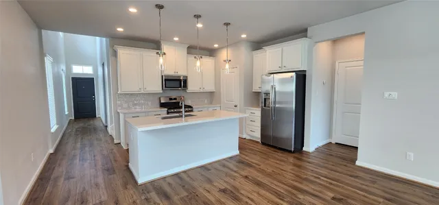 a kitchen with a sink stove and refrigerator