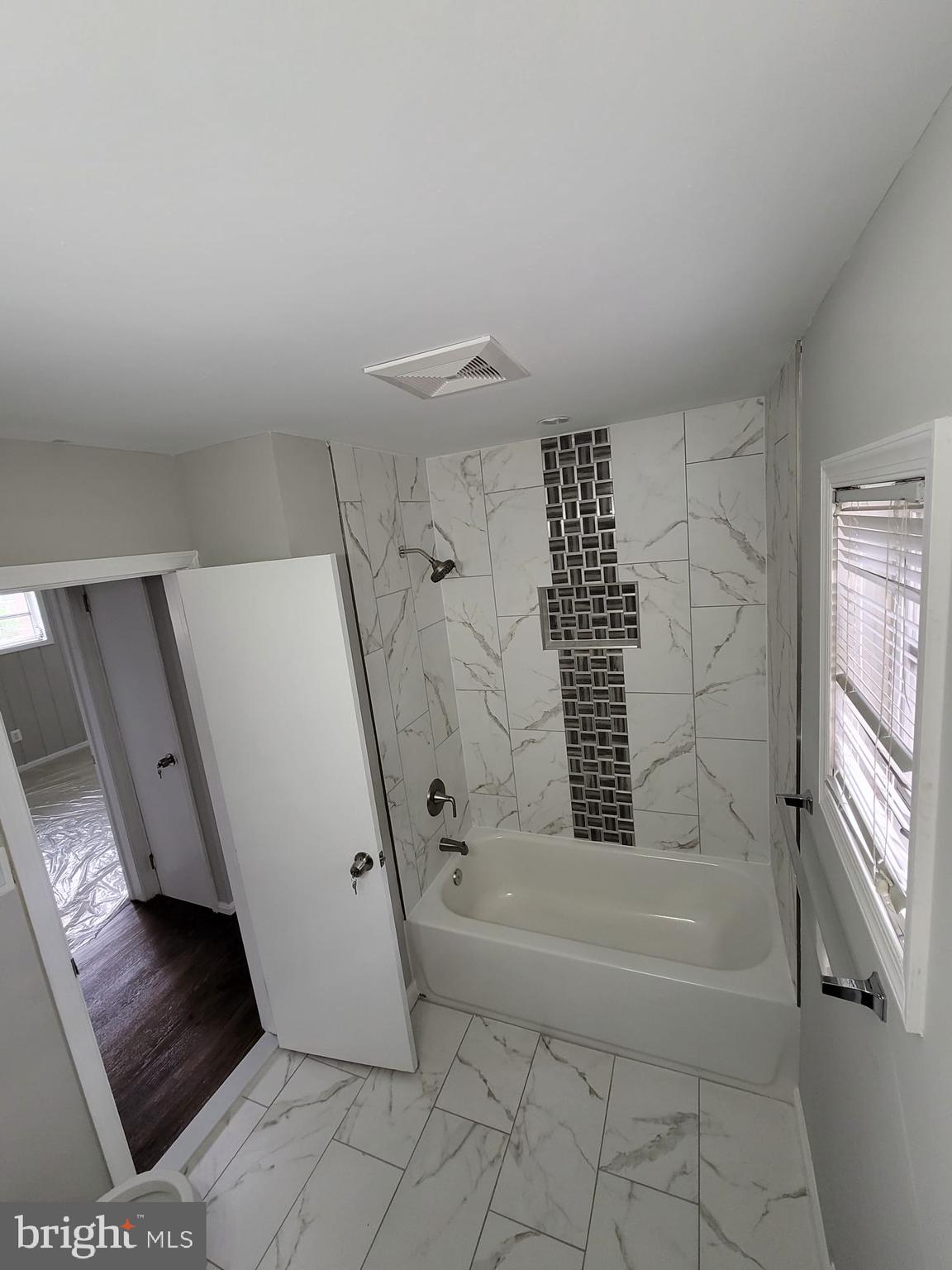 4516 Bennion Road Silver Spring, MD 20906 - Photo 8 of 24 a bathroom with a bathtub and a shower