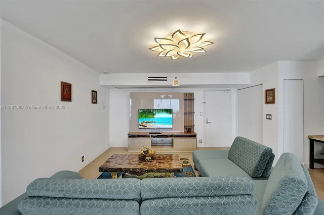 a living room with furniture a large window and a flat screen tv