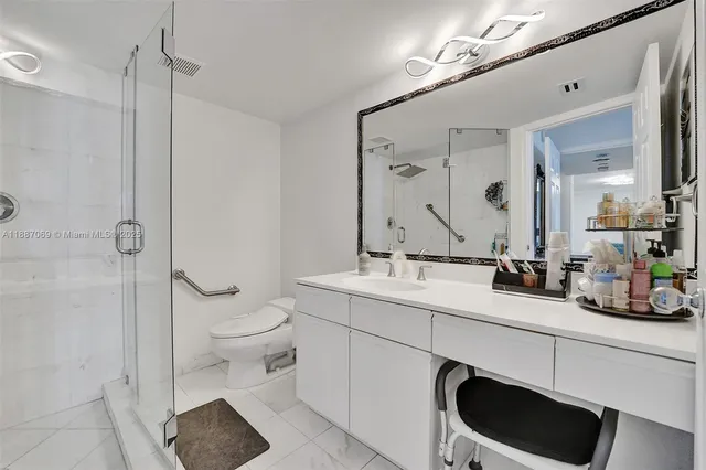 a bathroom with a toilet sink and shower