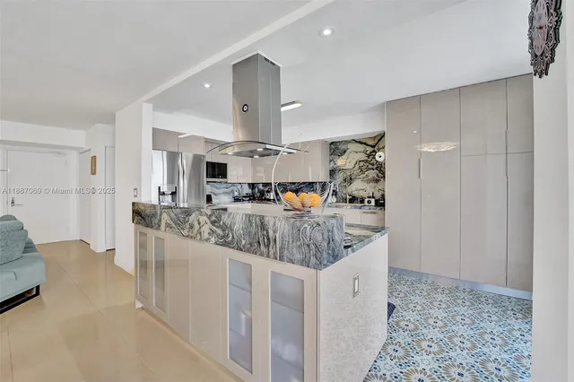 a kitchen with stainless steel appliances granite countertop a sink and a refrigerator
