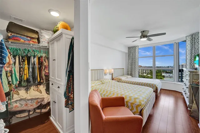 a living room with a bed furniture and a large window