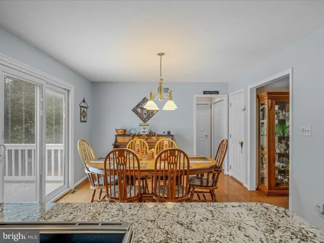 a dining room with furniture a chandelier and wooden floor