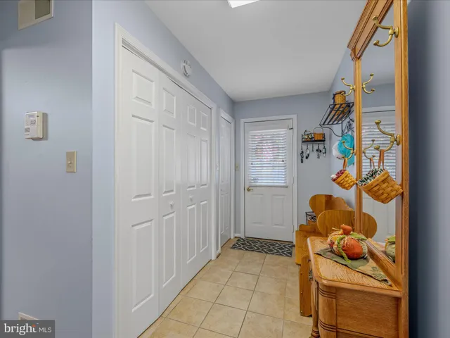 a bathroom with a granite countertop toilet a sink and a mirror