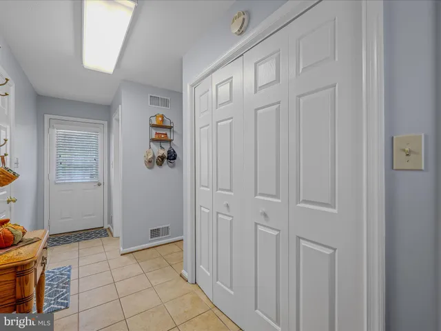 a spacious bedroom with a bed and a chandelier