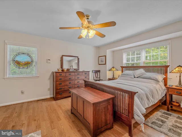 a bathroom with a granite countertop sink a large mirror and a light fixture