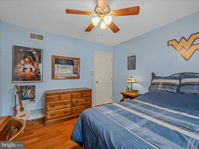 a living room with furniture gym equipment and a chandelier