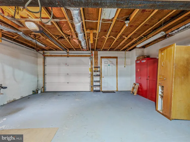 a view of a patio with table and chairs and potted plants with wooden fence