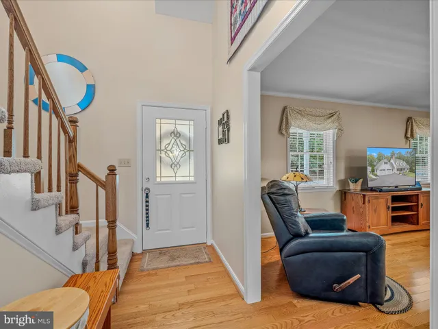 a living room with furniture large window and a fireplace