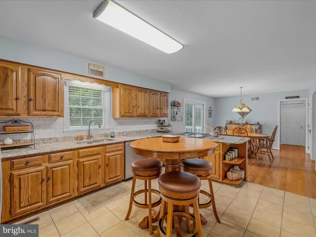a kitchen with stainless steel appliances a stove a sink and a refrigerator