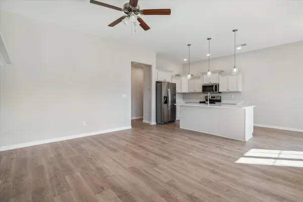 a view of a kitchen with a sink wooden floor and a window