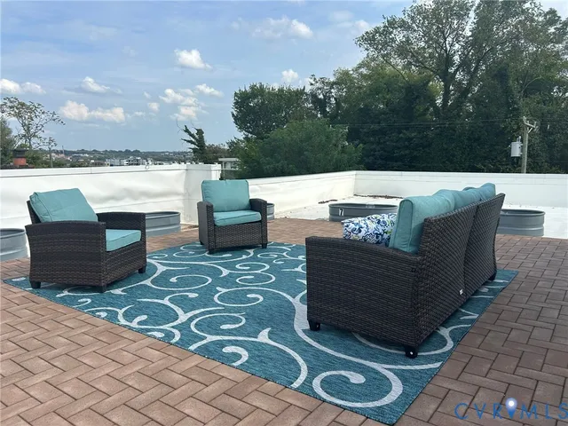 a view of a couches and a table in the patio