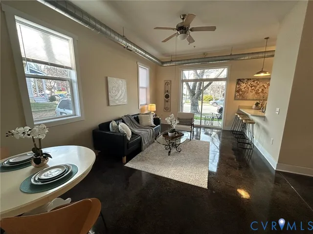 a living room with furniture and a chandelier
