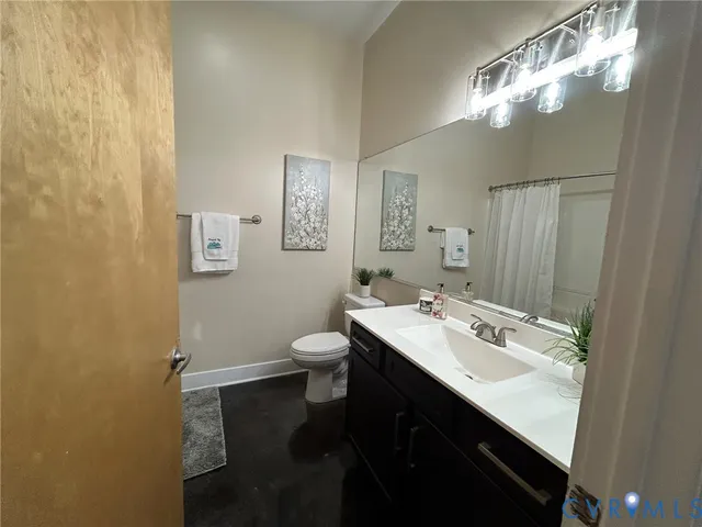 a bathroom with a sink toilet and a mirror